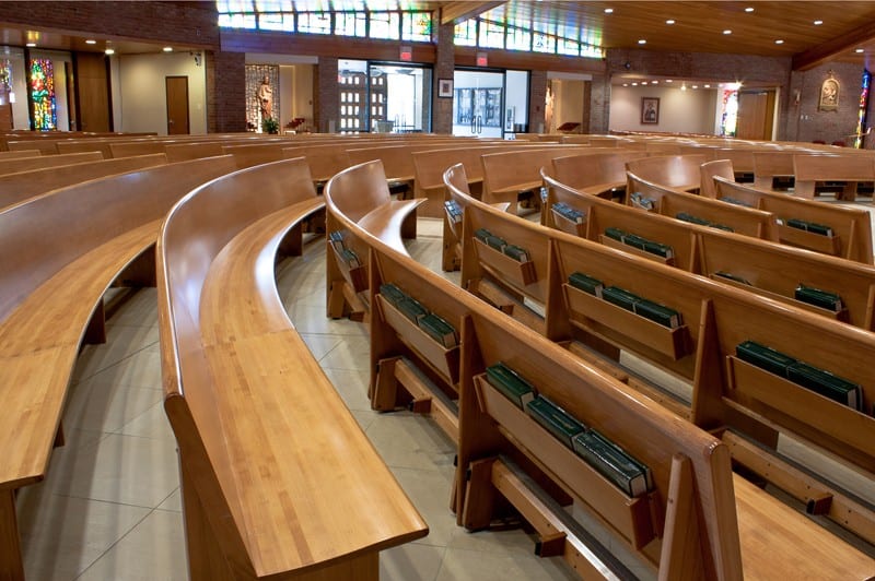 curved pew with bible holder