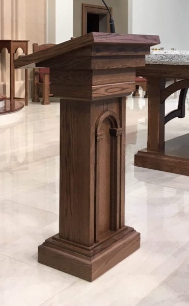 A dark wooden lectern at a church.