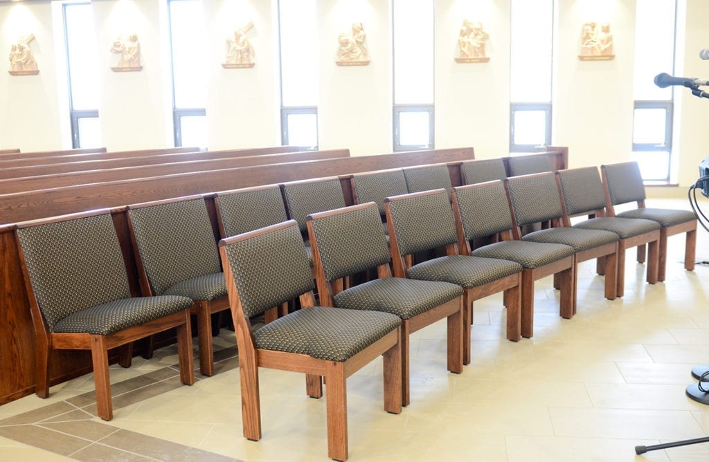 Row of chairs in front of pews