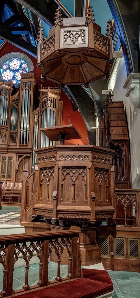 A wooden pulpit at the front of a church.