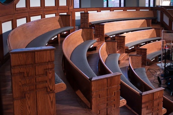 curved pew benches in an elevated design