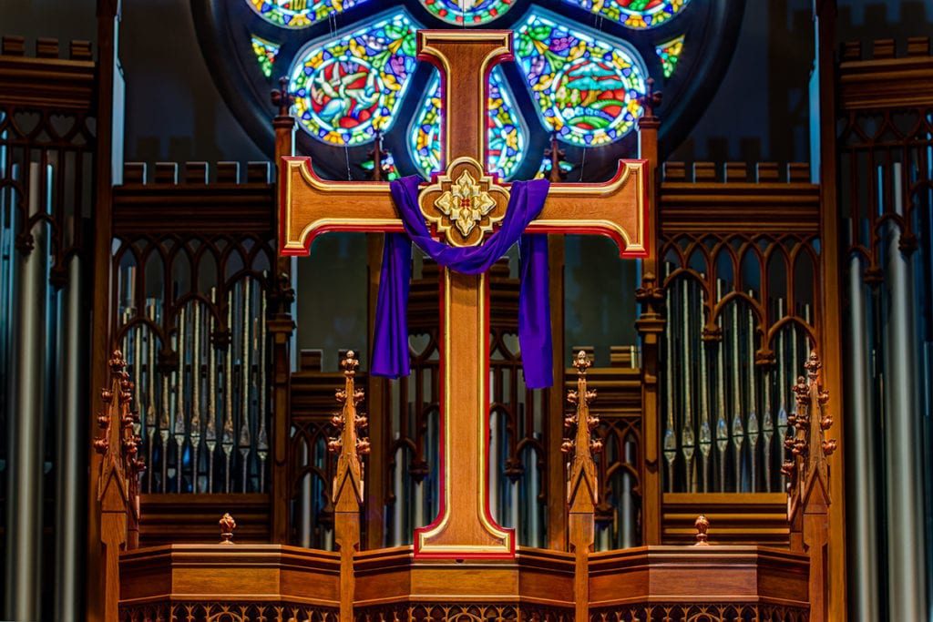cross with stained glass in background