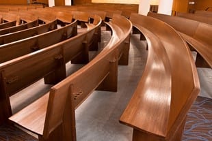 Curved wooden church pews at the Redeemer Presbyterian Church