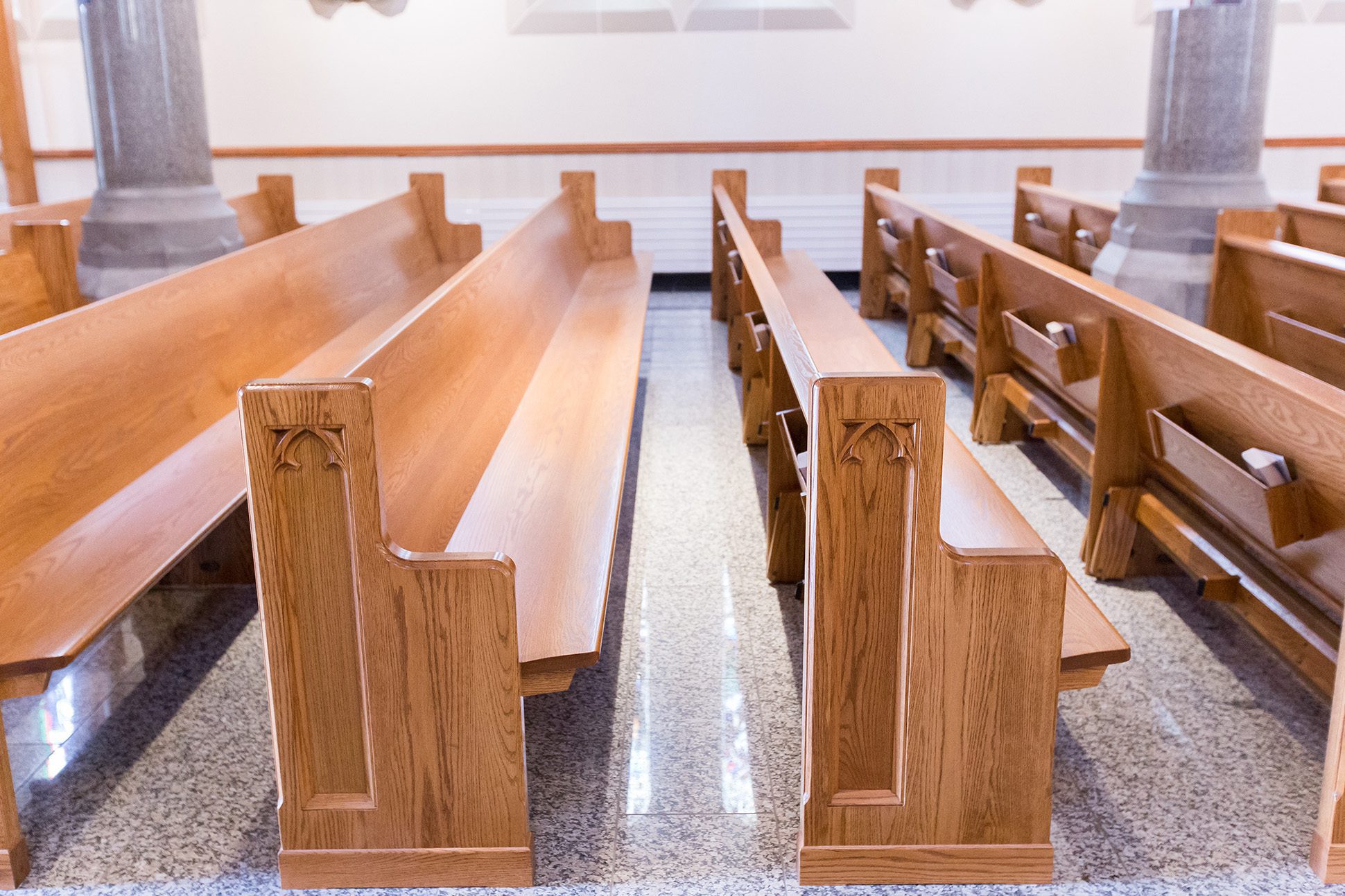 Straight wooden pews at St. Mary’s Catholic Church feature ornate pew ends.