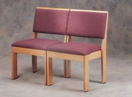 A double-seated chair with red upholstery and light-colored wood.