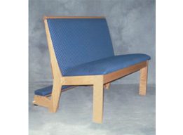 A blue upholstered chair with a kneeler in the back.