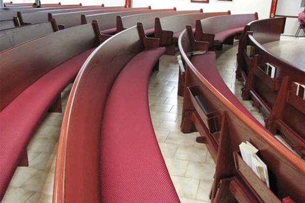curved pew with maroon colored cushion
